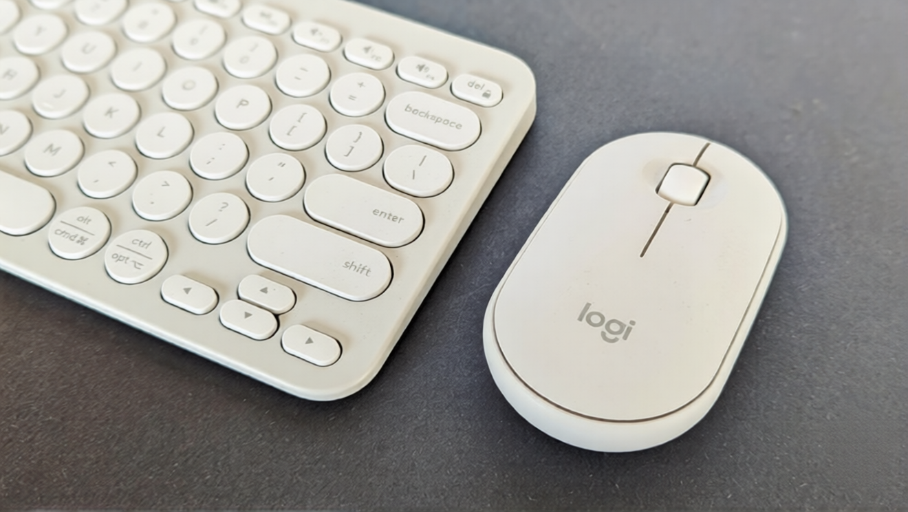 A sleek Logitech Pebble 2 Combo featuring a minimalist wireless keyboard and mouse placed on a clean desk, showcasing its compact design, soft pastel color, and modern aesthetic during first impressions.